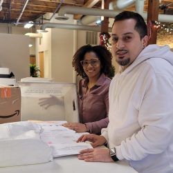 Two employees of New York Registered Agent LLC sort mail in the Albany office.