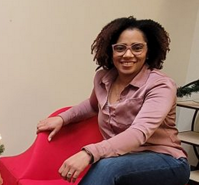 A woman sits in the office of New York Registered Agent.