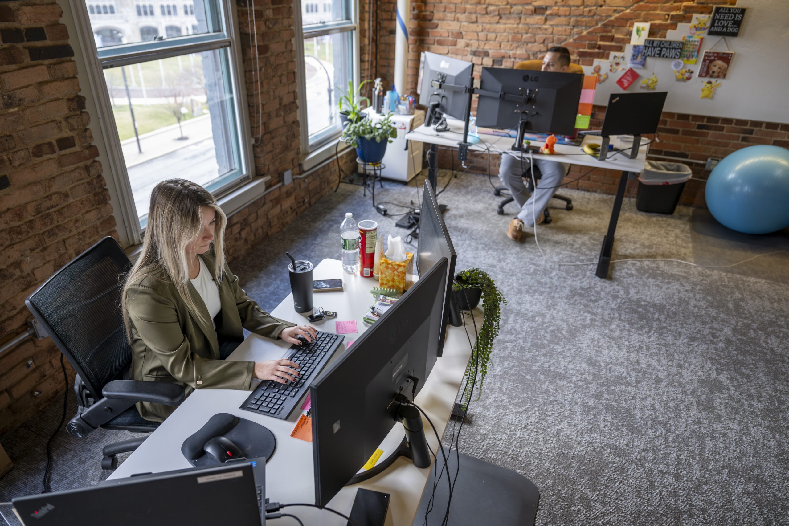 Two employees of New York Registered Agent sit at desks inside the company's Albany office.